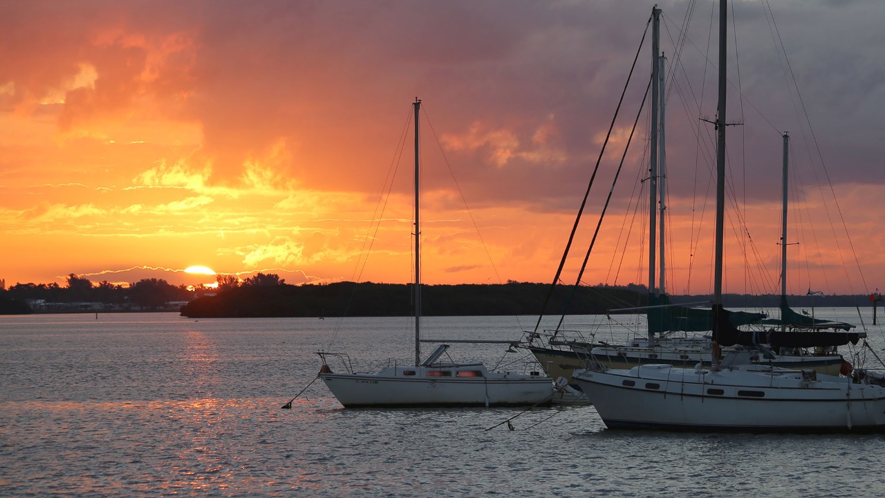 The sun rises over boats moored at Anna Maria Island. Photo by Charles Williams